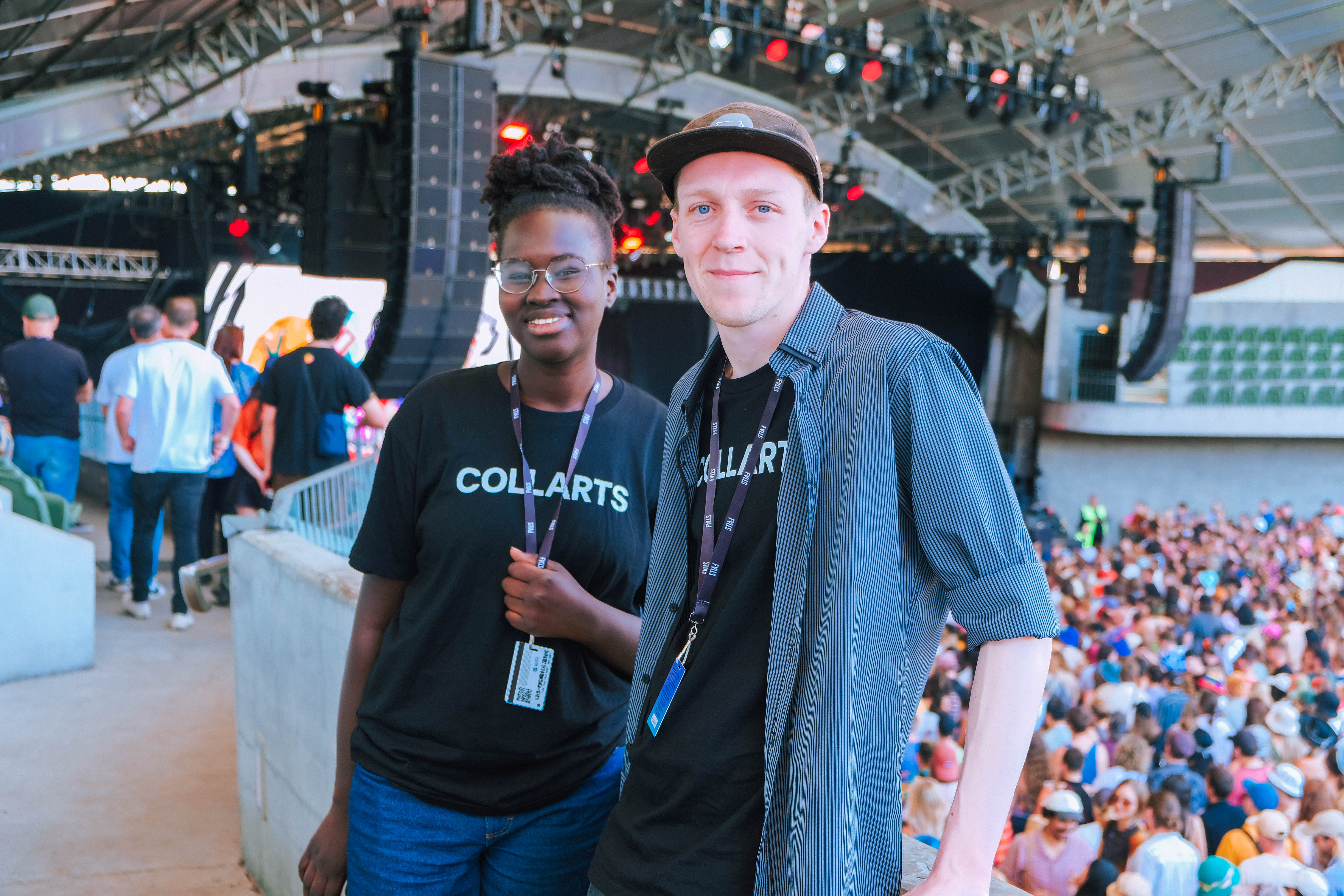 Two smiling Collarts Event Management and Audio Production students working at a music festival