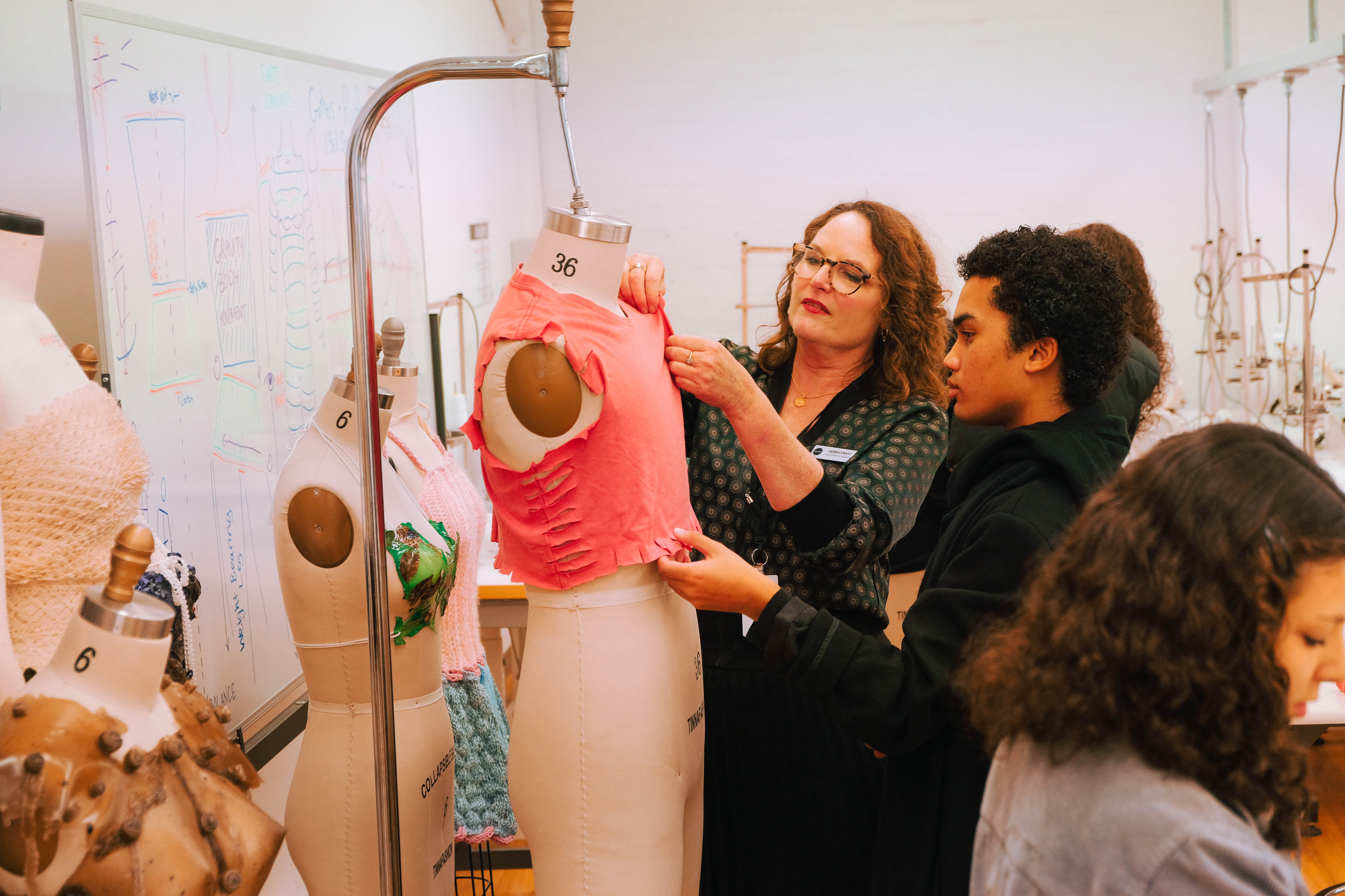 Collarts fashion teacher demonstrating on a mannequin with student