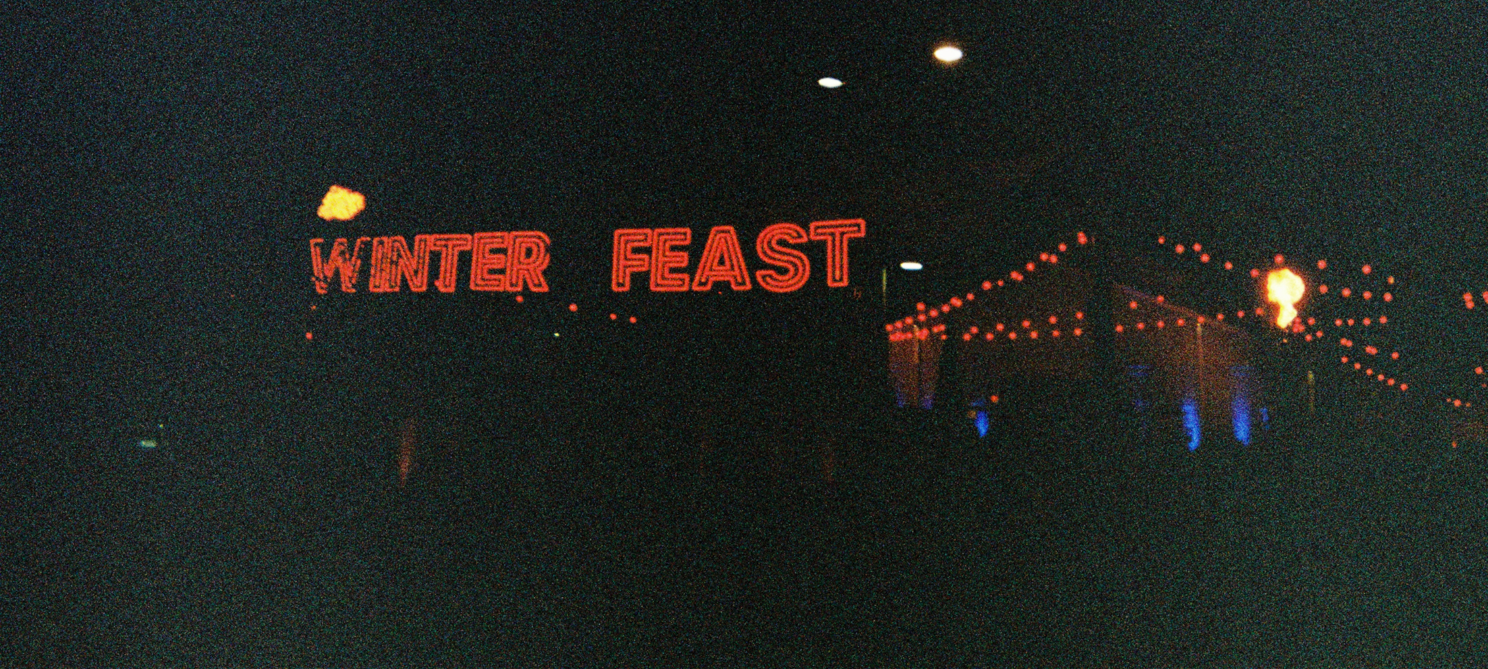 Dark photo of a tent at Dark Mofo with the words Winter Feast